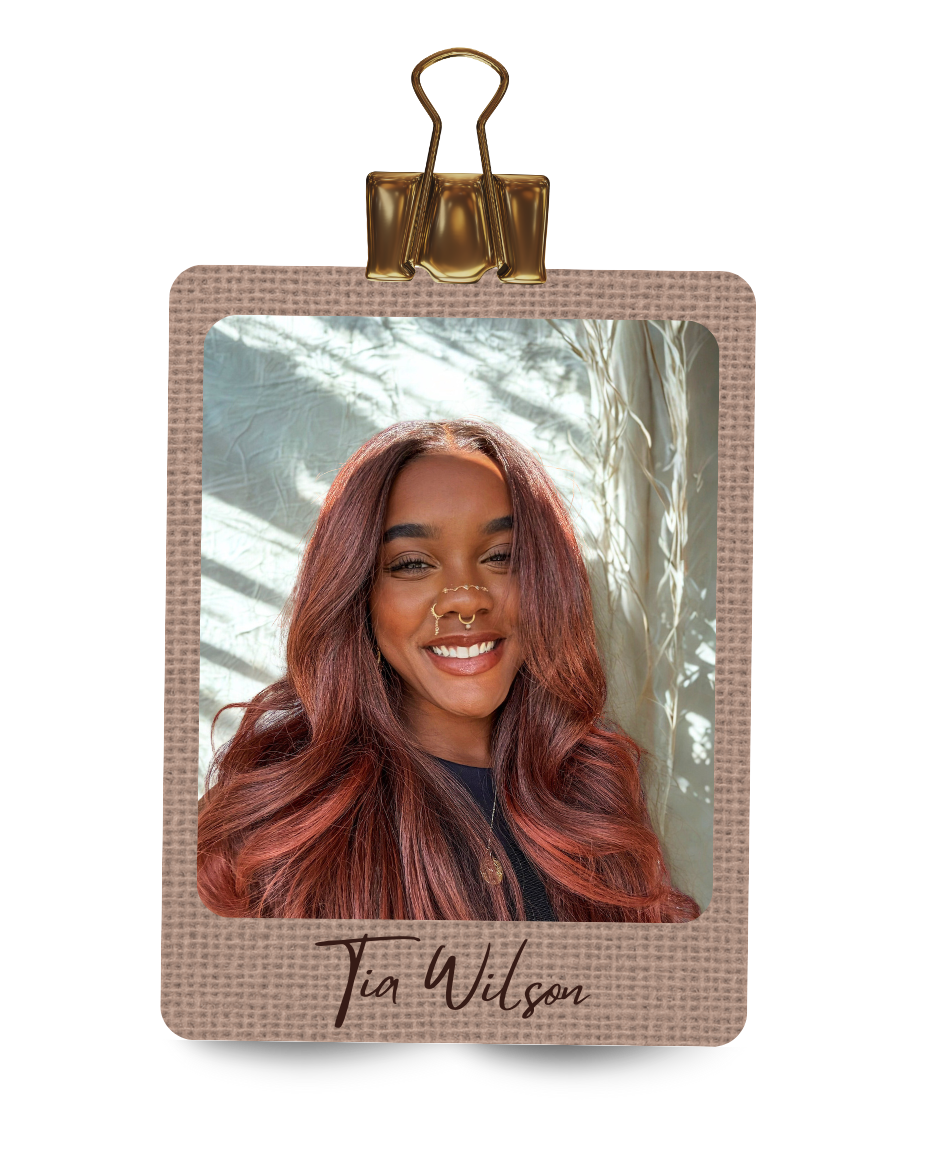 Rectangular photo frame with a portrait of a woman with red hair and the name 'Tia Wilson' on a white background.